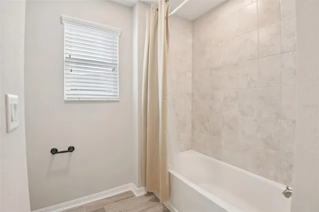 a white bath tub sitting next to a window