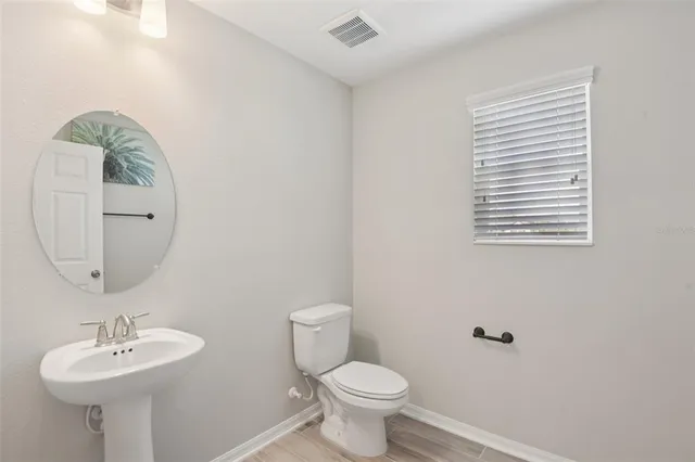 a bathroom with a sink a mirror and a toilet