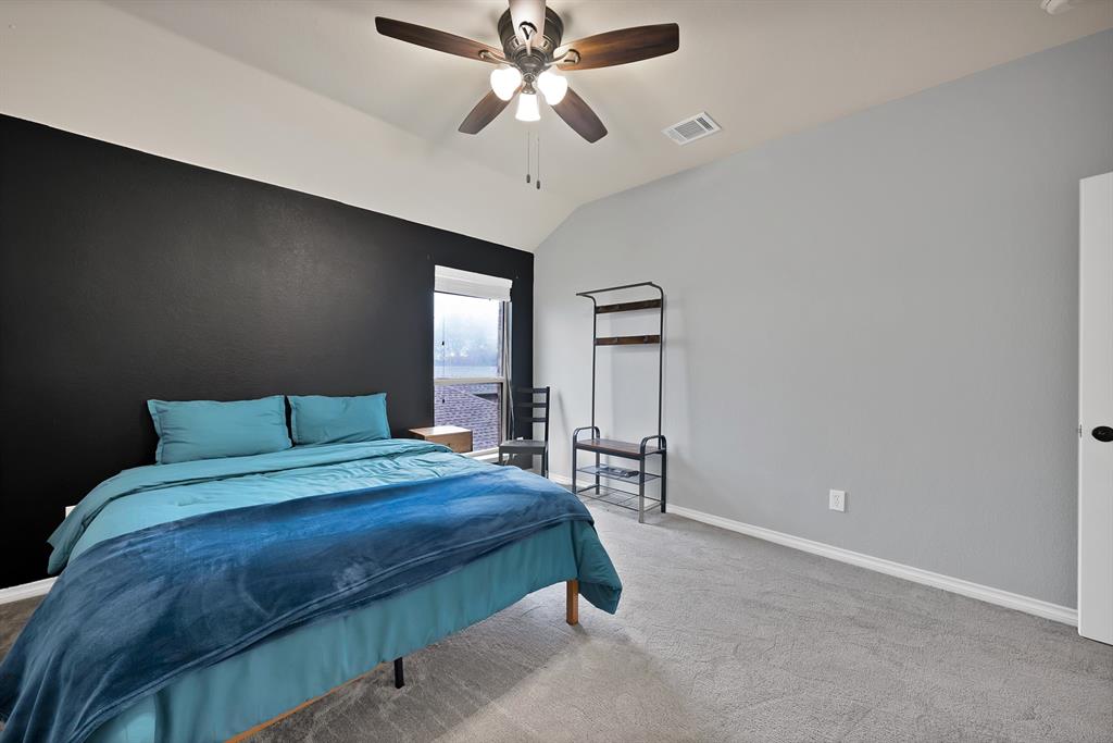 3822 Spring Run Lane Melissa, TX 75454 - Photo 30 of 39 a bedroom with a bed and a chandelier