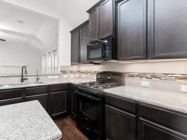 a kitchen with a sink and cabinets