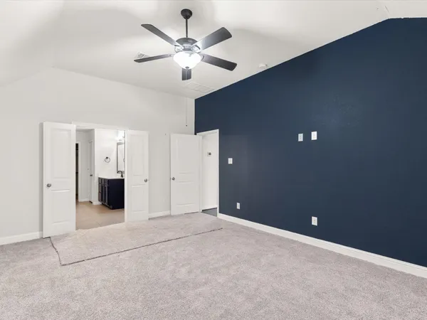 en empty room with windows and fan