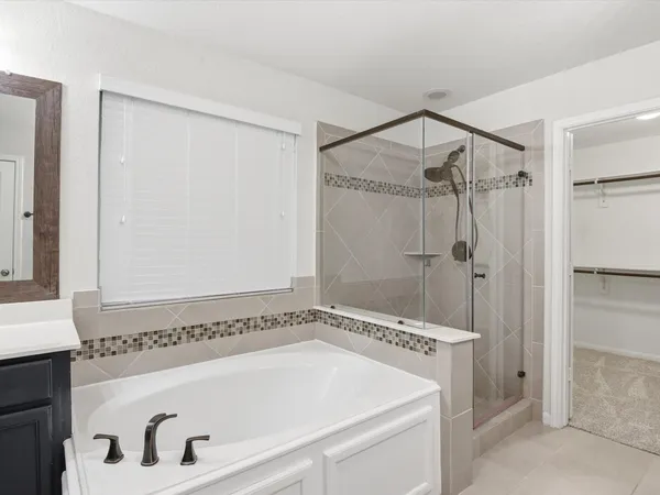 a bathroom with a tub and a shower