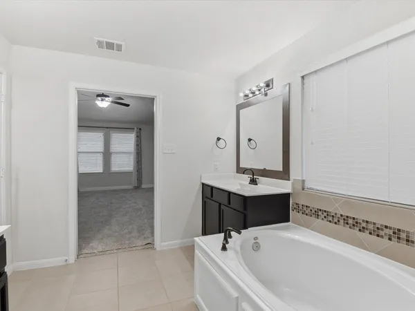 a bathroom with a bathtub and a sink