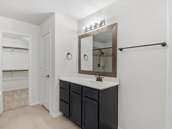 a bathroom with a double vanity sink and mirror