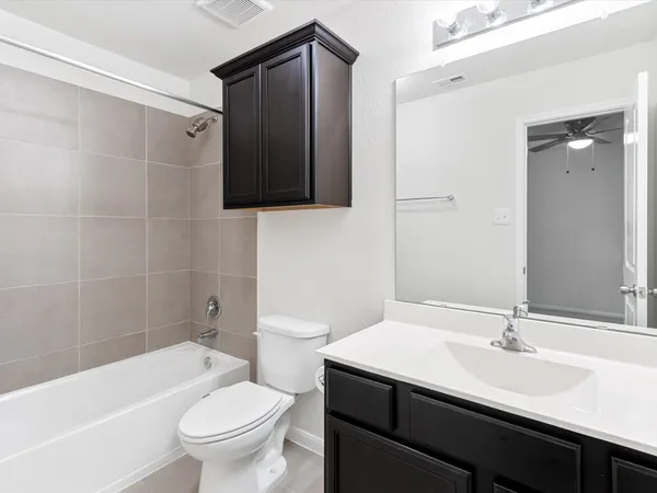 a bathroom with a sink toilet a mirror and shower