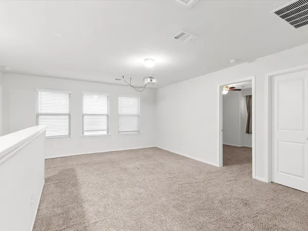 an empty room with windows and closet