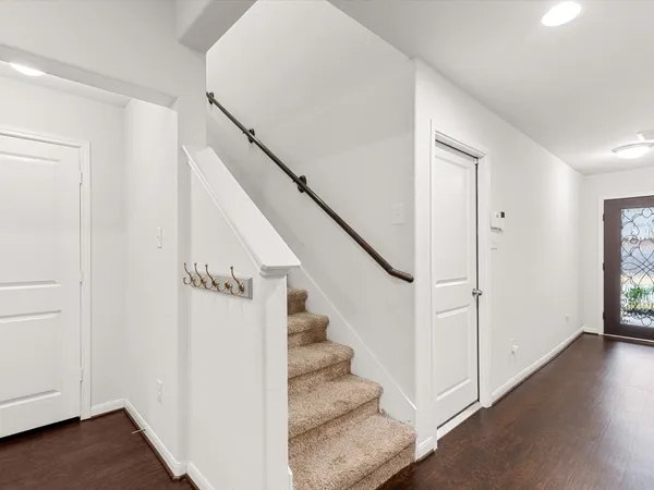 a view of entryway with stairs and wooden floor