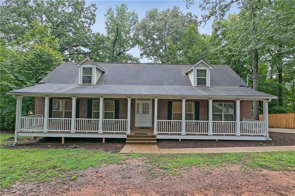 2946 Stone Road Atlanta, GA 30344 - Photo 1 of 1 a front view of a house with a garden