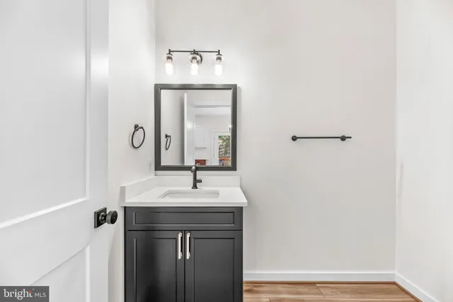 an empty room with windows and chandelier fan