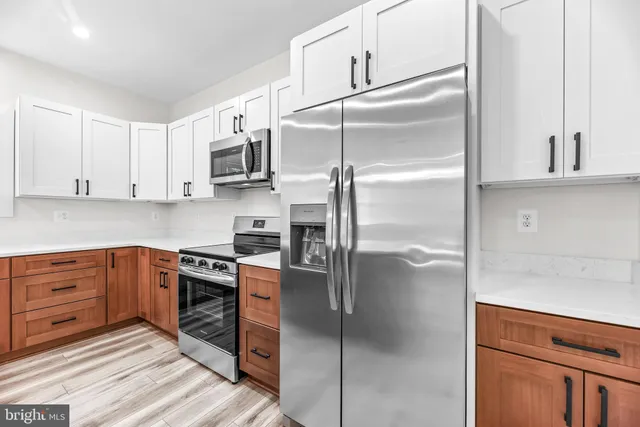 a kitchen with stainless steel appliances granite countertop a sink and dishwasher with wooden floor
