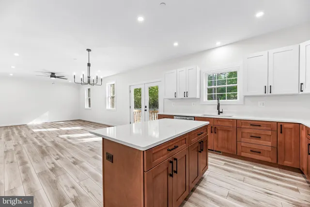 a kitchen with stainless steel appliances granite countertop a sink and a stove