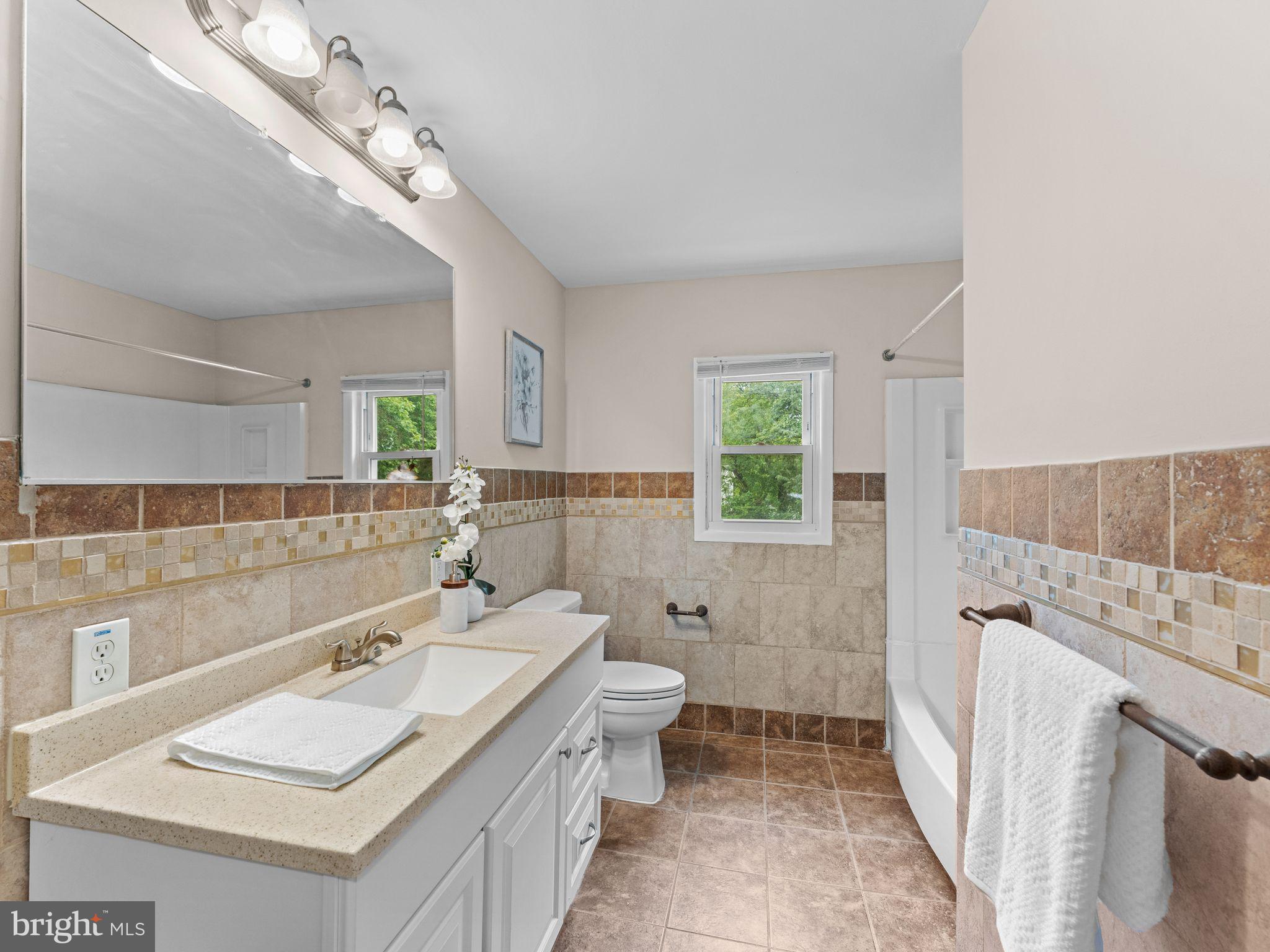28 Dunham Loop Berlin, NJ 08009 - Photo 15 of 45 a bathroom with a sink a toilet a mirror and shower