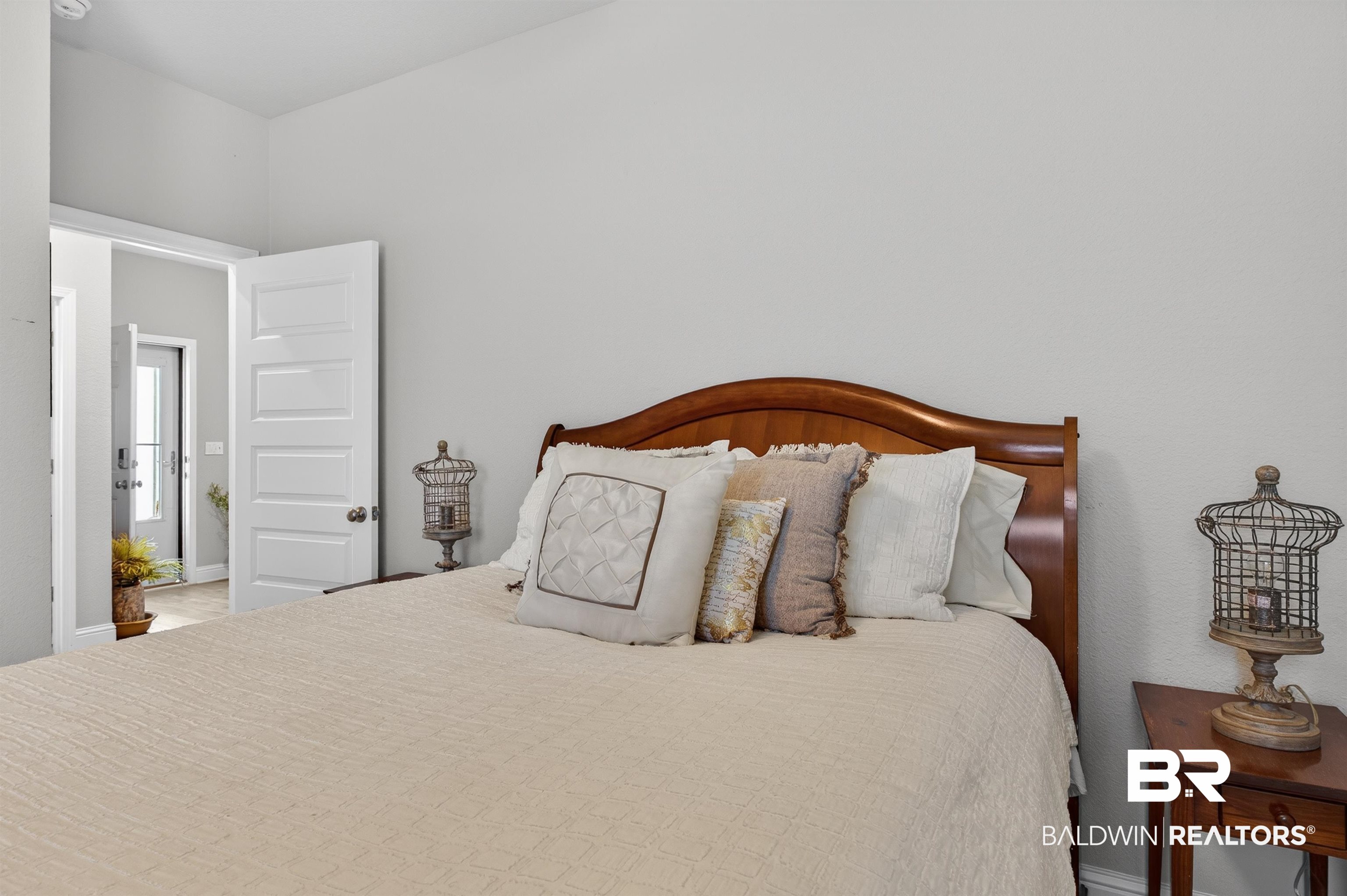 8735 Bronze Lane Foley, AL 36535 - Photo 31 of 58 Light gray painted walls define this space, featuring a classic wood-finish headboard