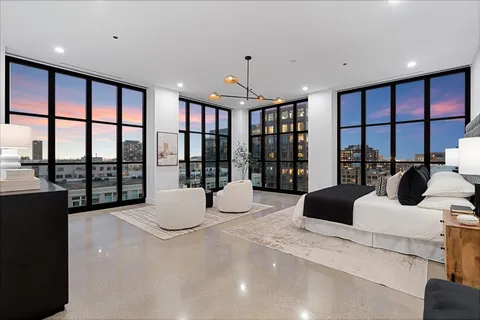 a bedroom with a large bed and a large window