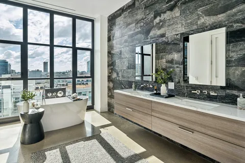 a room with kitchen island wooden floor and a potted plant
