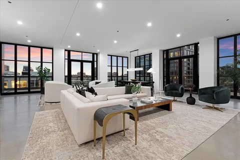 a living room with furniture large window and flat screen tv