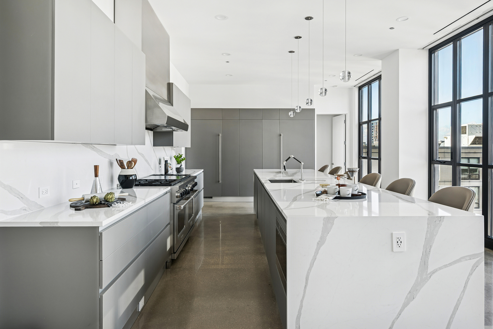 900 West Washington Boulevard, Unit PHW Chicago, IL 60607 - Photo 6 of 30 a kitchen with stainless steel appliances kitchen island a sink stove and cabinets
