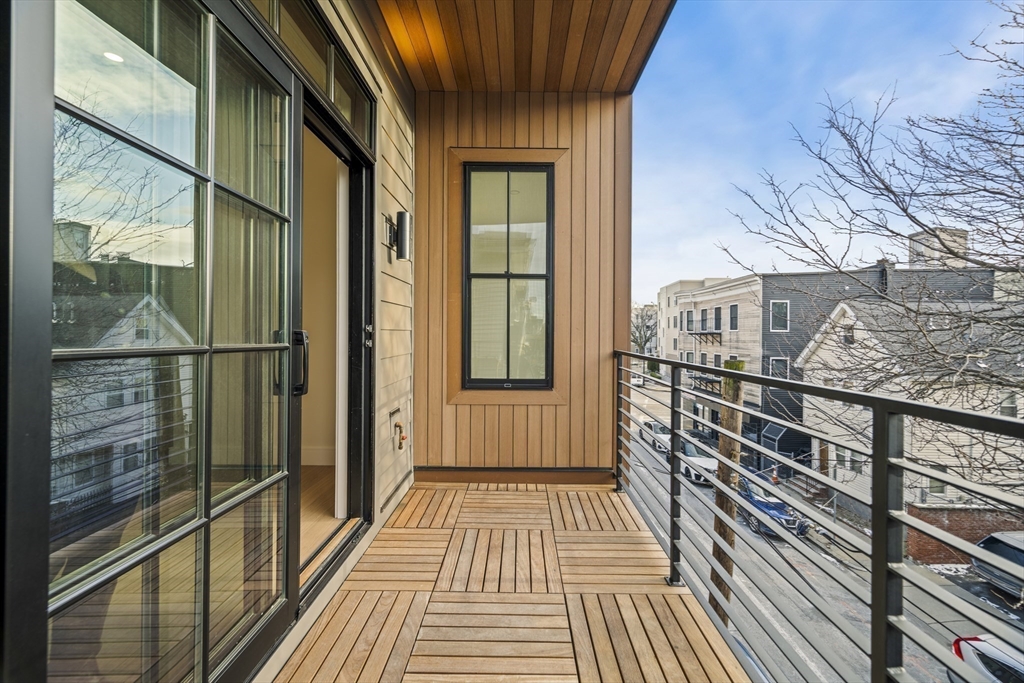 224 West 9th Street, Unit 4 Boston, MA 02127 - Photo 8 of 22 a view of a balcony with wooden floor and floor to ceiling window