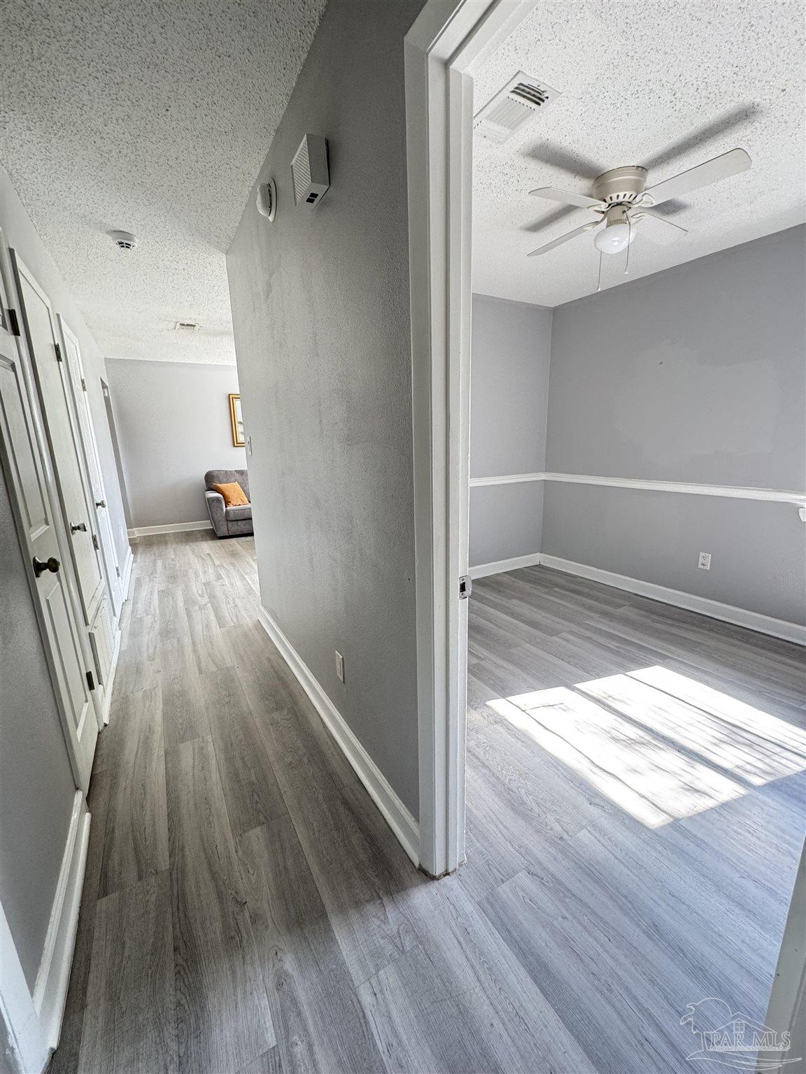 346 Quigley Road Pensacola, FL 32506 - Photo 11 of 28 a view of hallway with wooden floor and fan