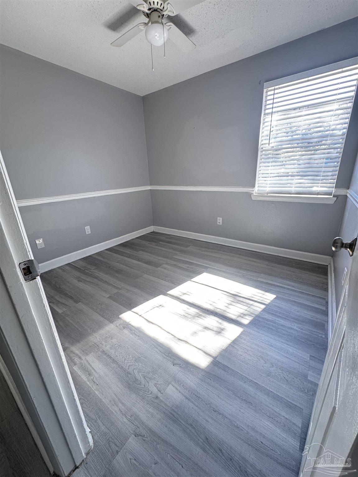 346 Quigley Road Pensacola, FL 32506 - Photo 12 of 28 a view of empty room with wooden floor and fan