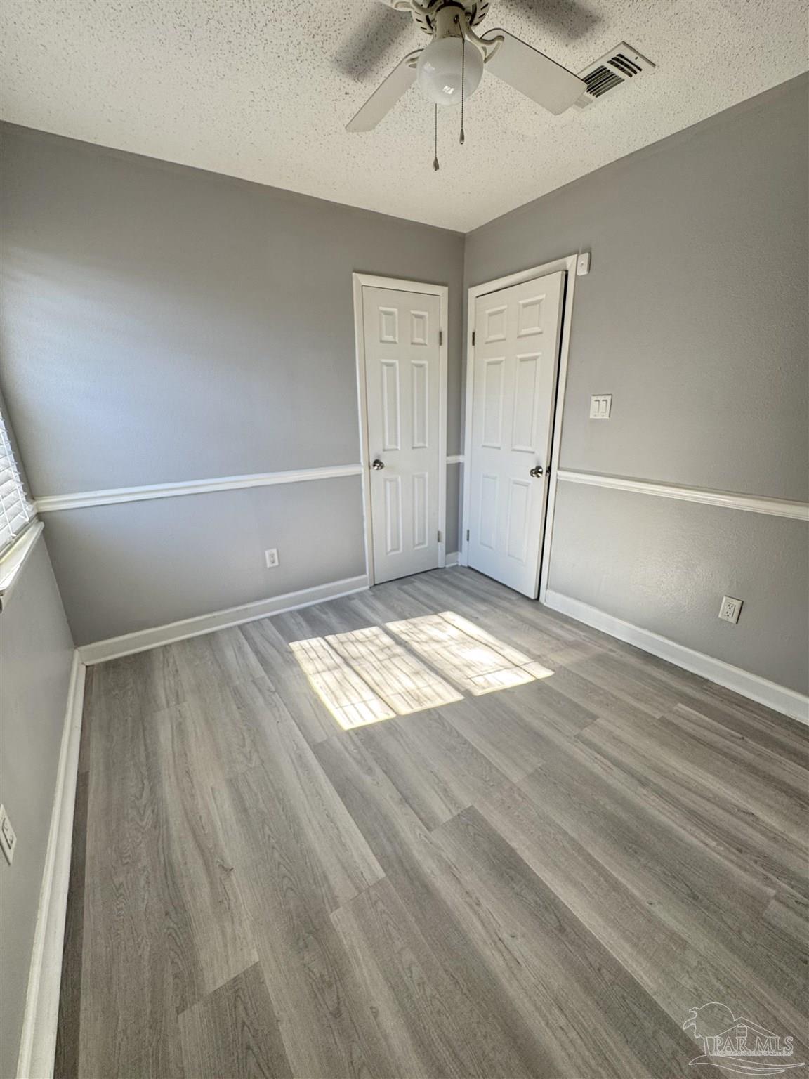 346 Quigley Road Pensacola, FL 32506 - Photo 13 of 28 wooden floor in an empty room