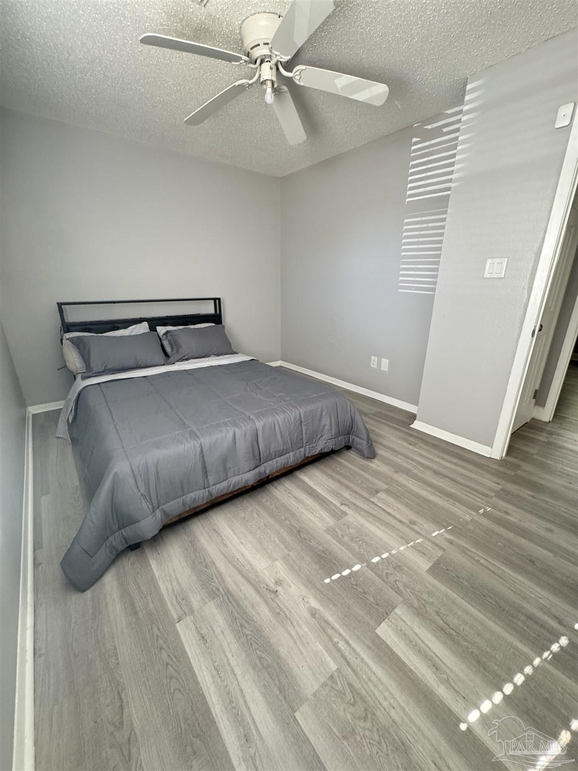 346 Quigley Road Pensacola, FL 32506 - Photo 16 of 28 a bedroom with a bed and a ceiling fan