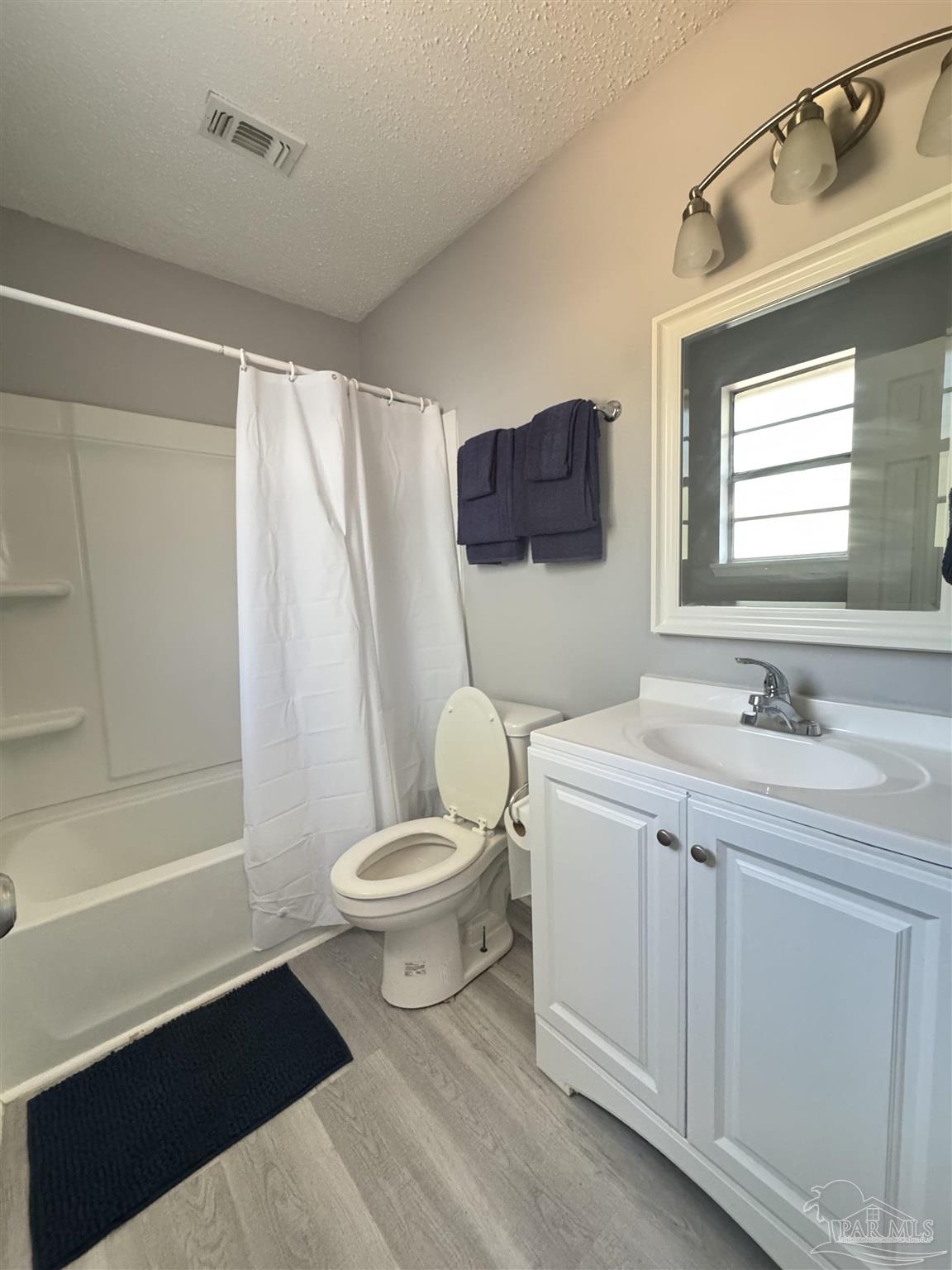 346 Quigley Road Pensacola, FL 32506 - Photo 20 of 28 a bathroom with a toilet sink a mirror and shower