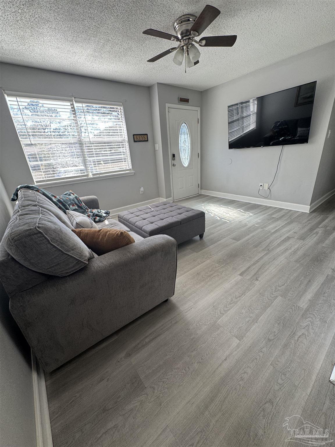 346 Quigley Road Pensacola, FL 32506 - Photo 4 of 28 a living room with furniture and a flat screen tv