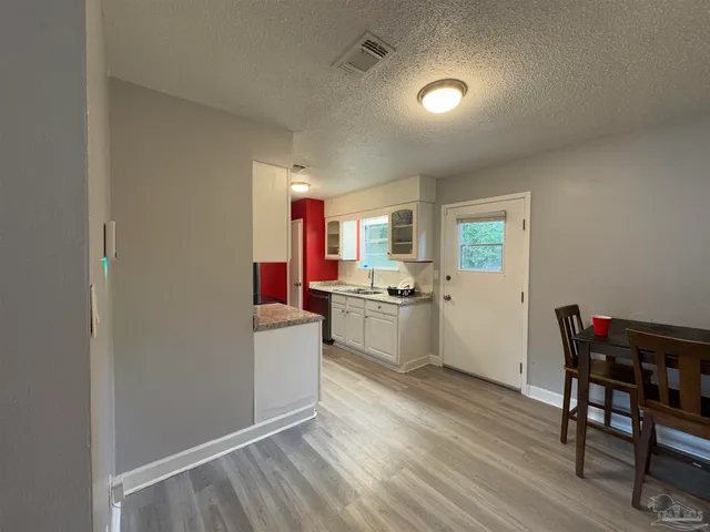 a kitchen with a table and chairs in it
