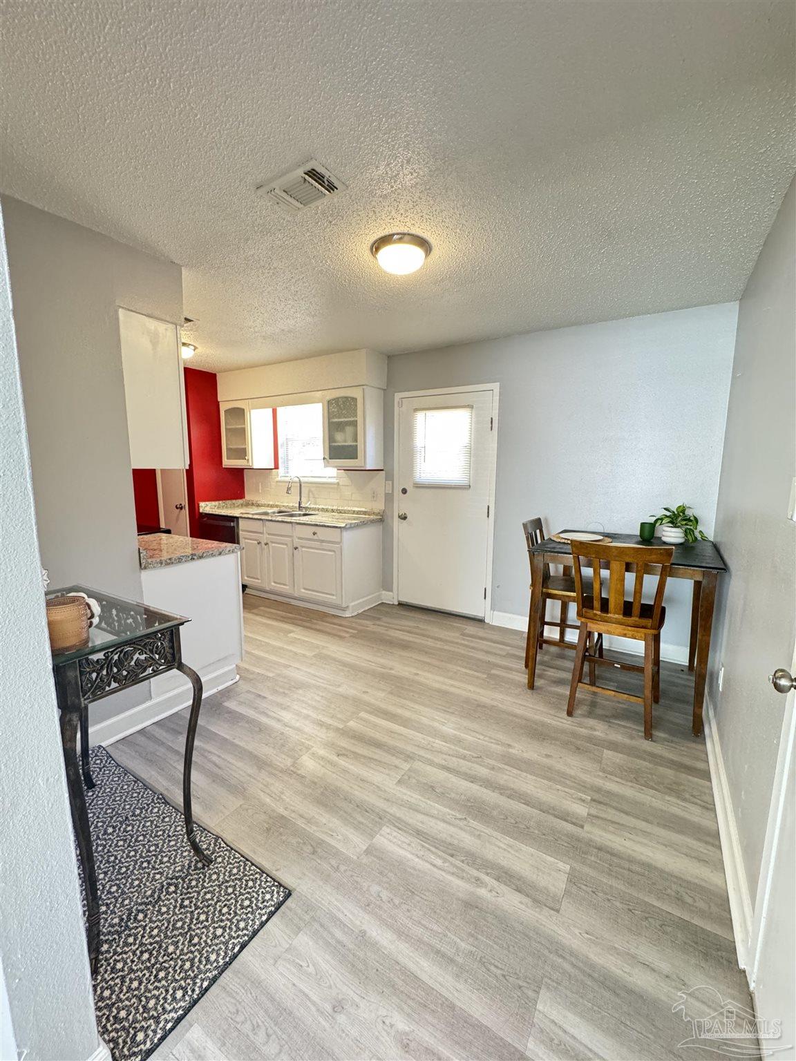 346 Quigley Road Pensacola, FL 32506 - Photo 6 of 28 a living room with furniture and a wooden floor