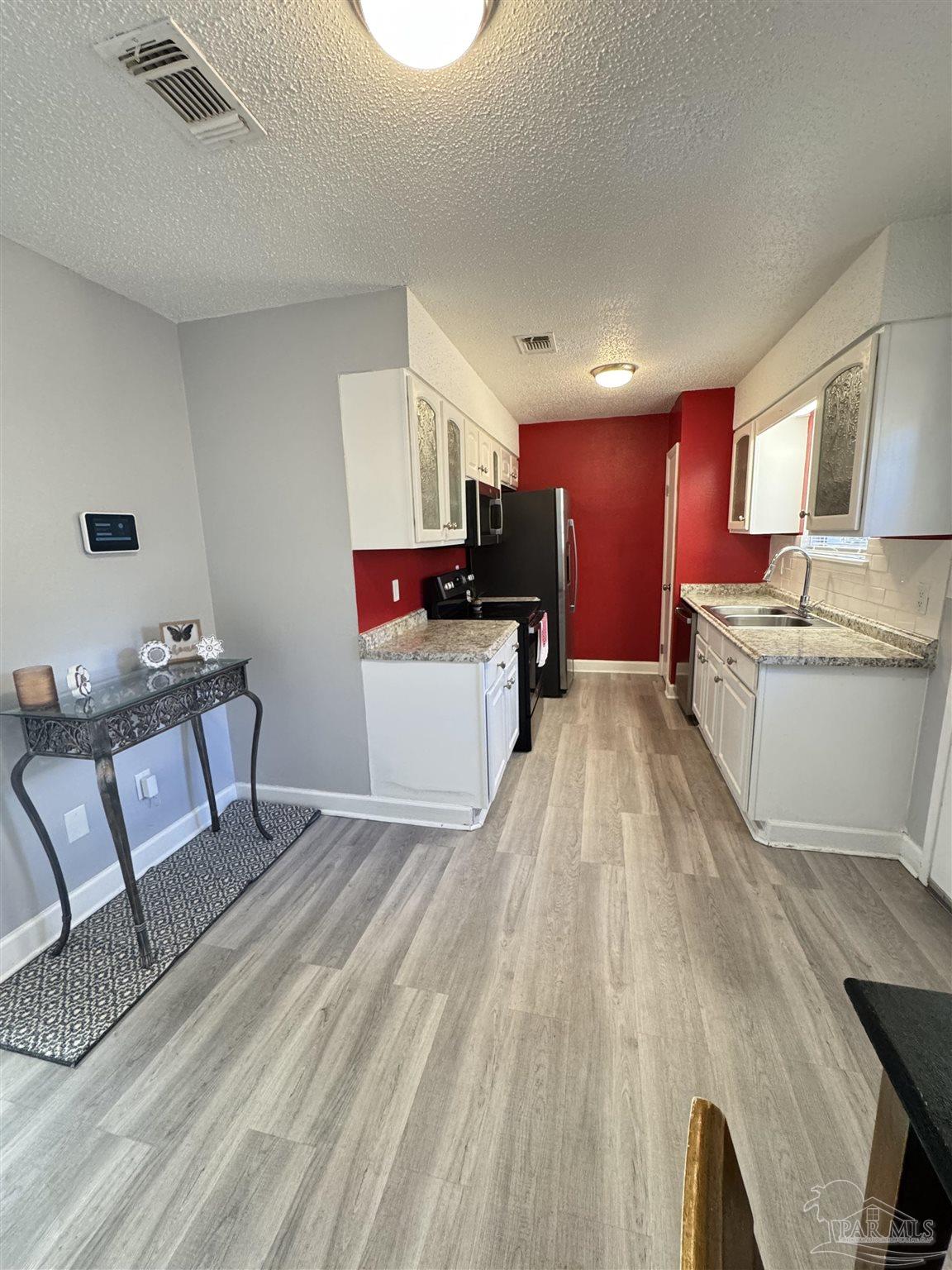 346 Quigley Road Pensacola, FL 32506 - Photo 7 of 28 a living room with furniture and a wooden floor