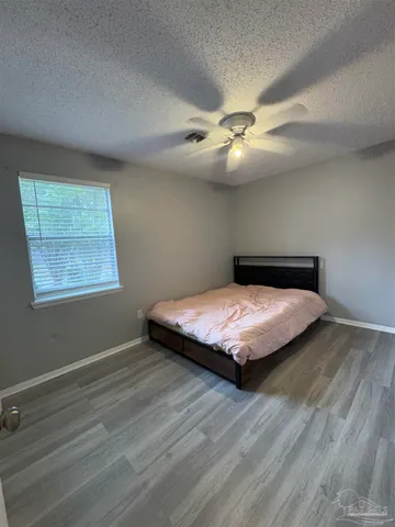 a bedroom with a bed and window