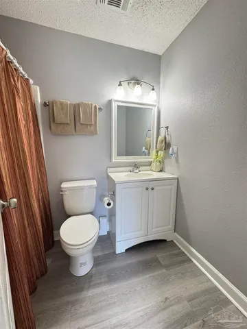 a bathroom with a sink toilet a mirror and vanity