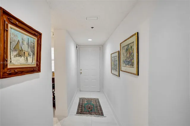 a view of a hallway with paintings on the wall