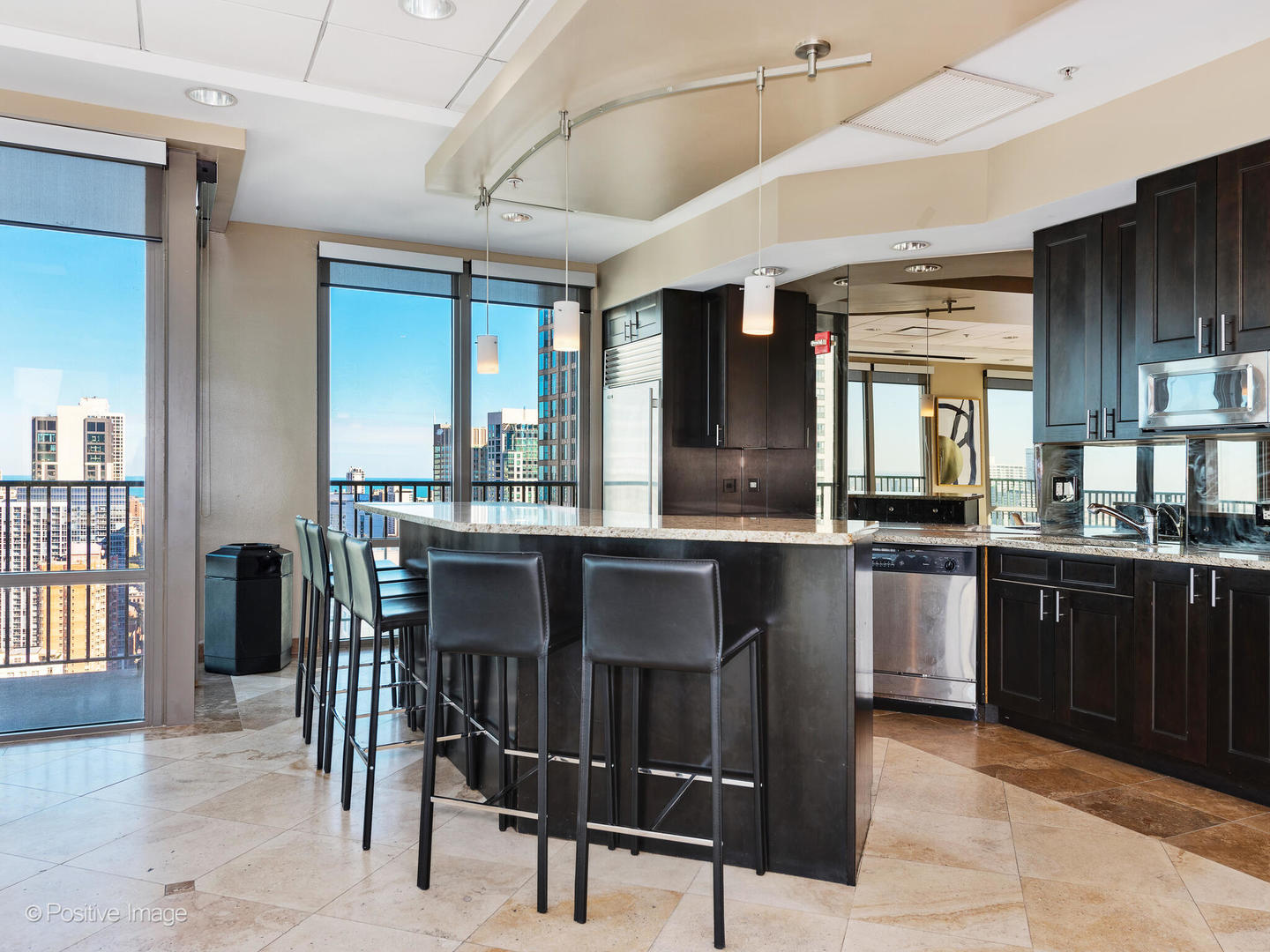 2 East Erie Street, Unit 3301 Chicago, IL 60611 - Photo 13 of 16 a kitchen with granite countertop a sink cabinets and stainless steel appliances