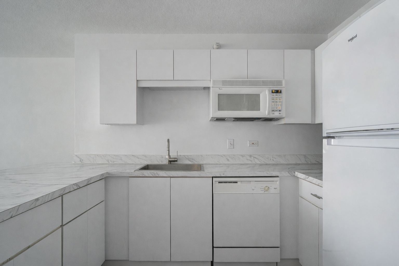 2 East Erie Street, Unit 3301 Chicago, IL 60611 - Photo 5 of 16 a kitchen with granite countertop white cabinets and a sink