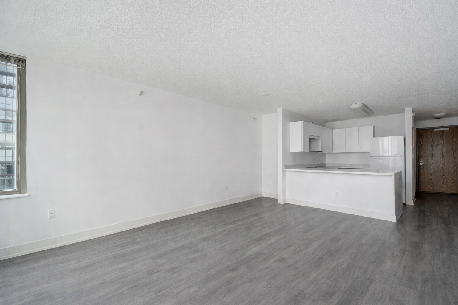 2 East Erie Street, Unit 3301 Chicago, IL 60611 - Photo 6 of 16 a view of a refrigerator in kitchen and wooden floor