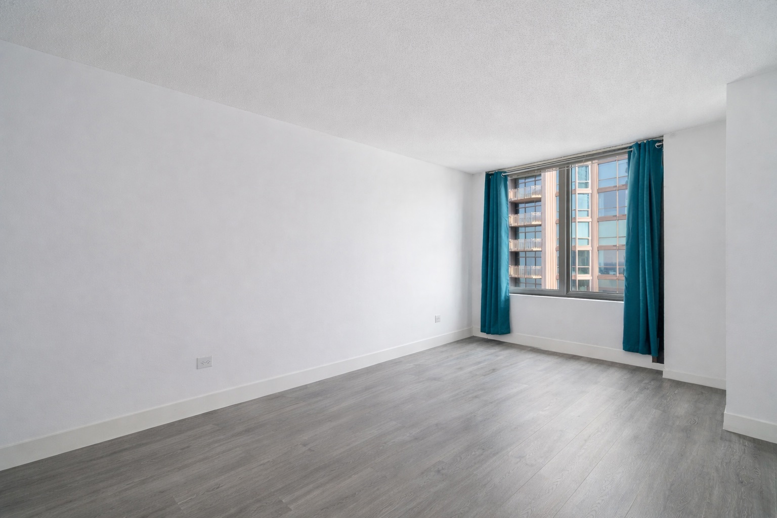 2 East Erie Street, Unit 3301 Chicago, IL 60611 - Photo 8 of 16 a view of an empty room with wooden floor and a window