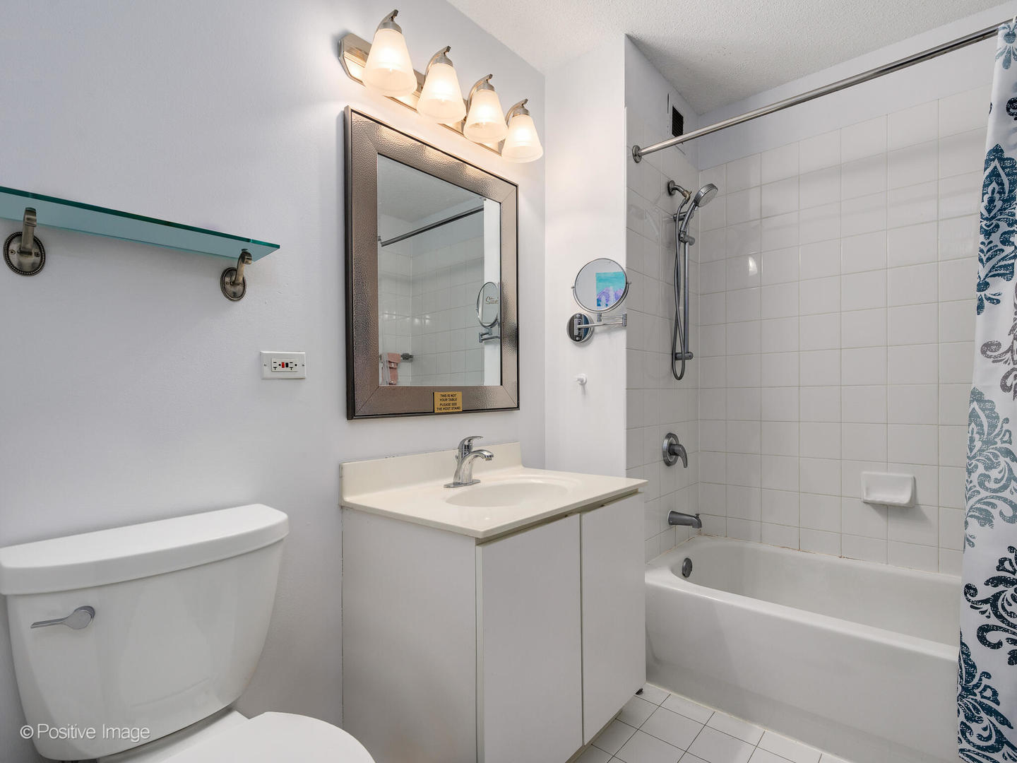 2 East Erie Street, Unit 3301 Chicago, IL 60611 - Photo 9 of 16 a bathroom with a sink a toilet and a mirror