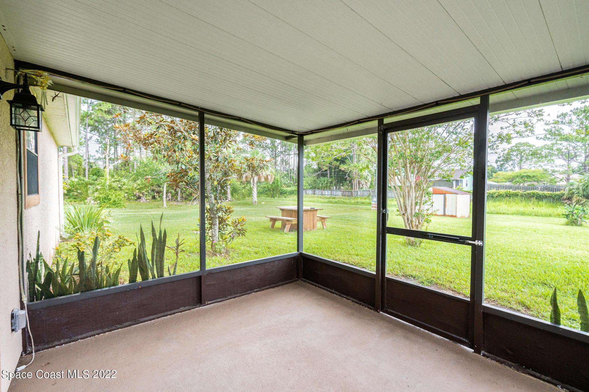1355 Seabold Road Southwest Palm Bay, FL 32908 - Photo 11 of 22 a view of an empty room with large windows