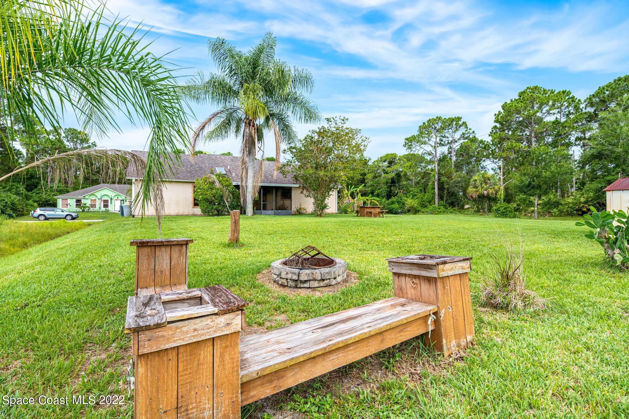 1355 Seabold Road Southwest Palm Bay, FL 32908 - Photo 15 of 22 a garden view with a sitting space