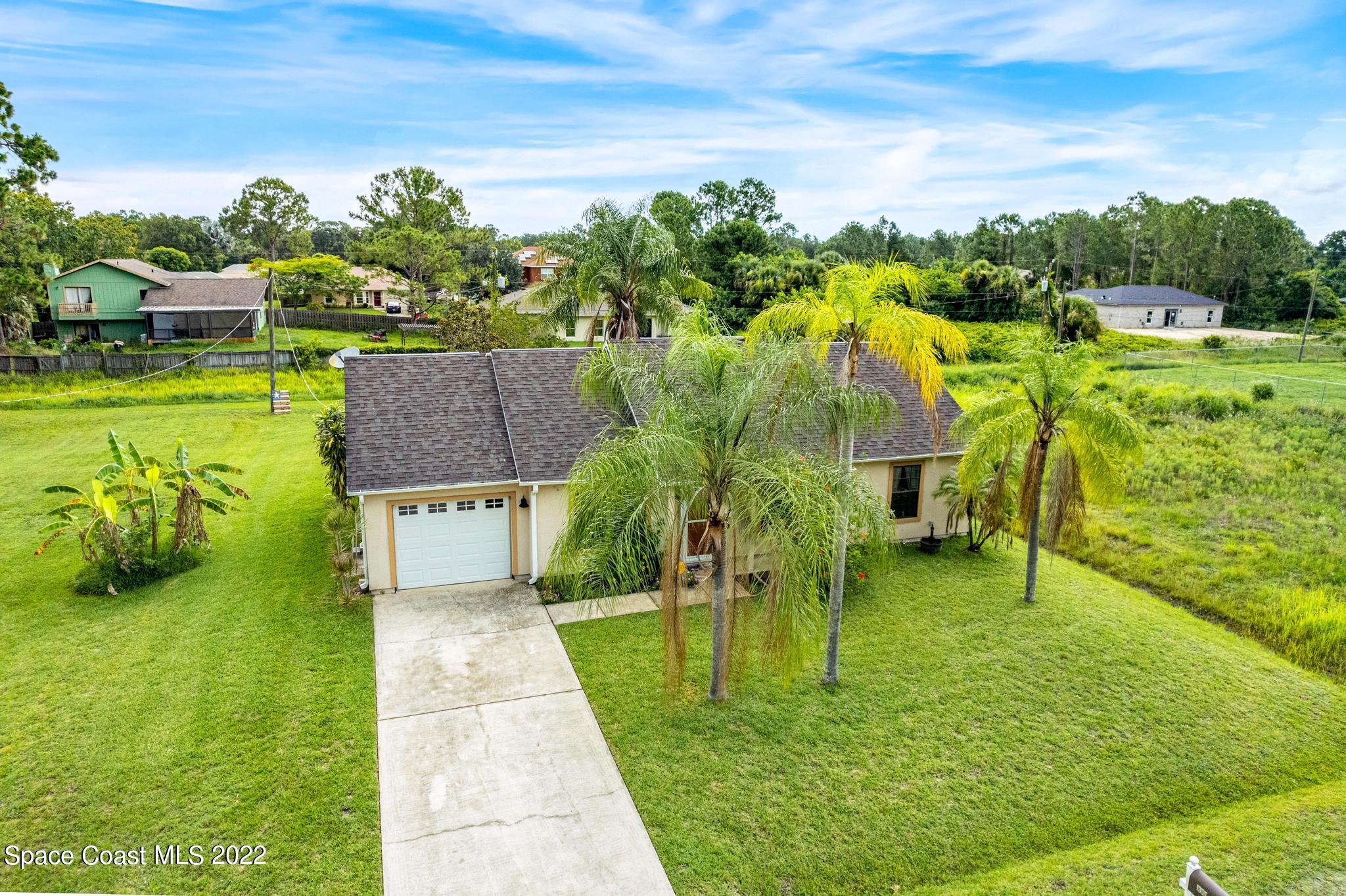 1355 Seabold Road Southwest Palm Bay, FL 32908 - Photo 22 of 22 a view of a swimming pool with a garden