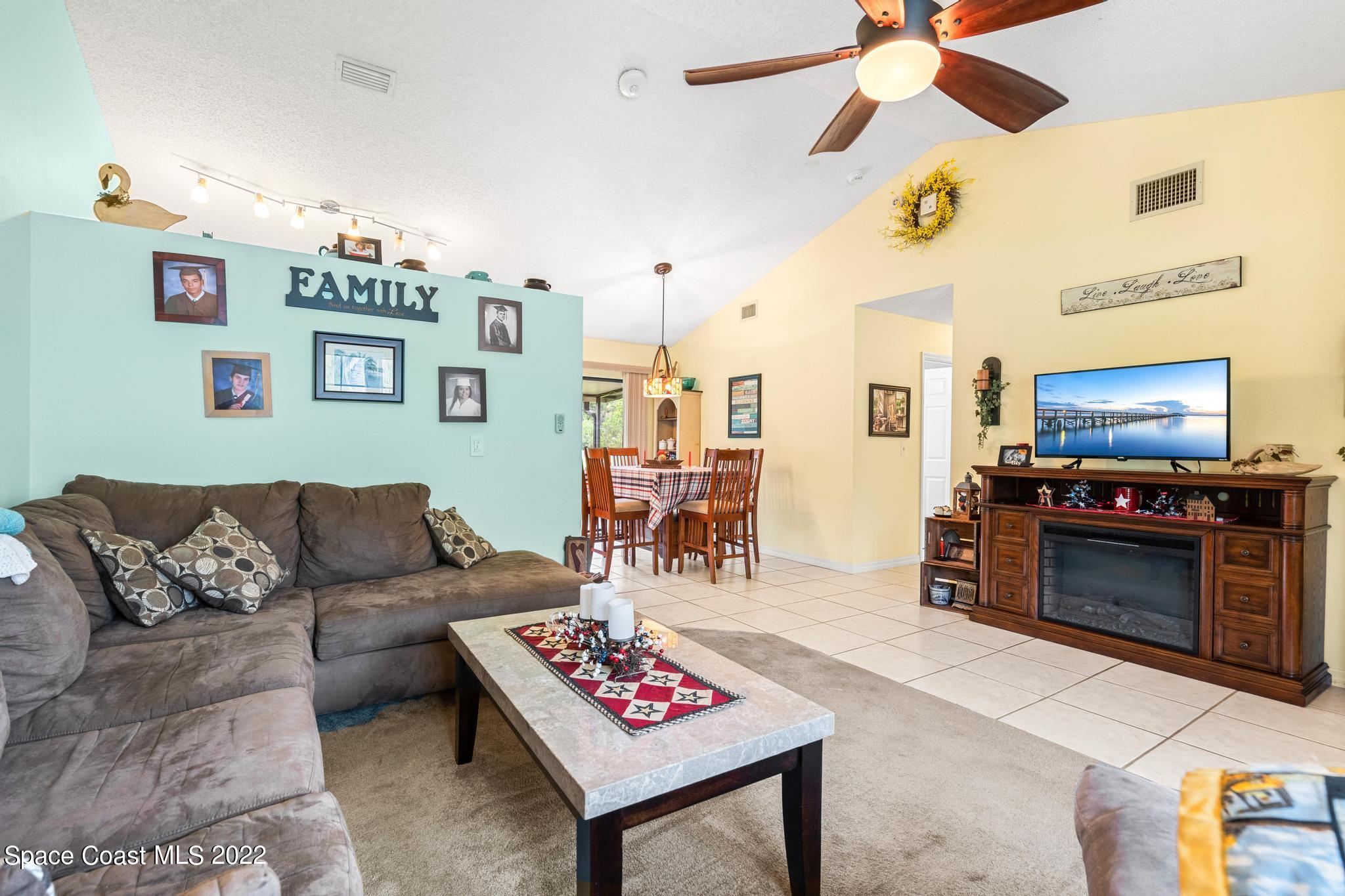 1355 Seabold Road Southwest Palm Bay, FL 32908 - Photo 3 of 22 a living room with furniture and a flat screen tv