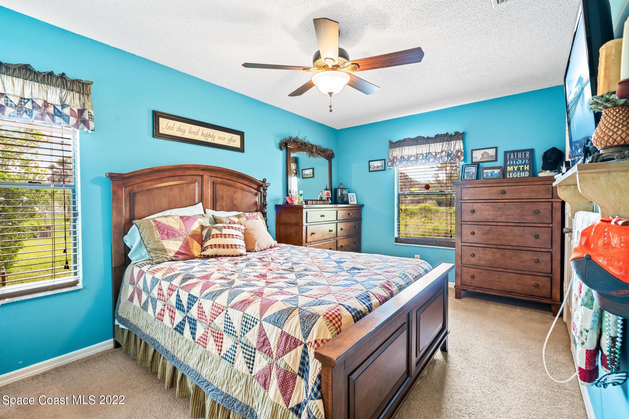 1355 Seabold Road Southwest Palm Bay, FL 32908 - Photo 7 of 22 a bedroom with a bed and a chandelier