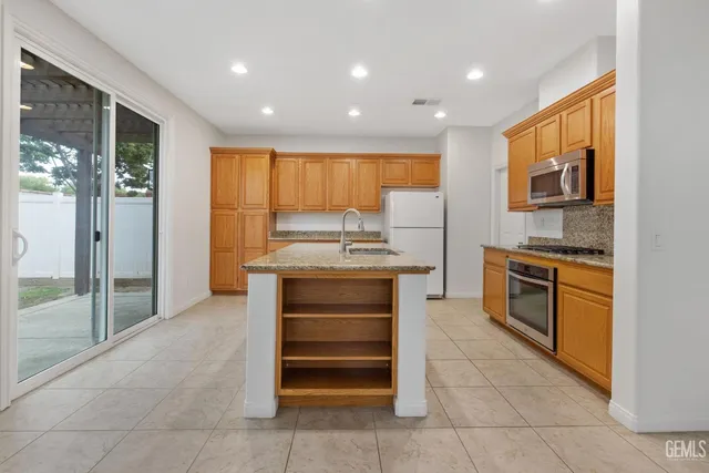 a kitchen with stainless steel appliances granite countertop a stove and a sink