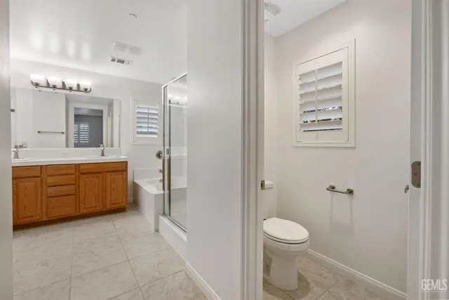 a spacious bathroom with a mirror a shower and a sink