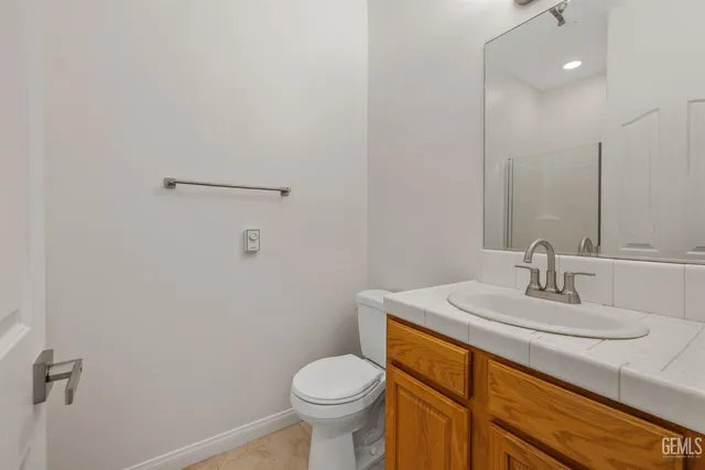a bathroom with a sink toilet and vanity
