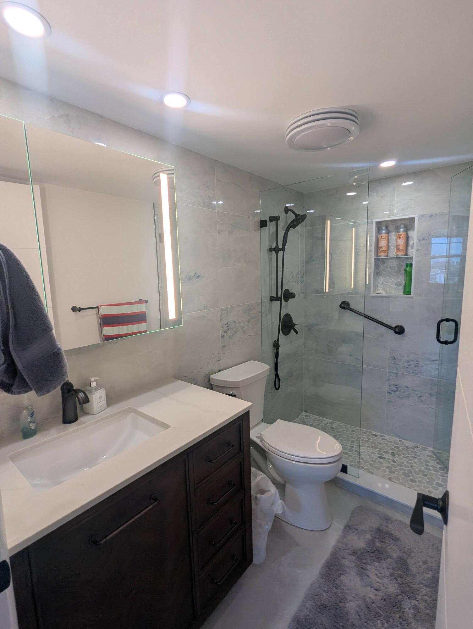 2121 North Ocean Boulevard, Unit 1006E Boca Raton, FL 33431 - Photo 43 of 64 a bathroom with a sink toilet and shower