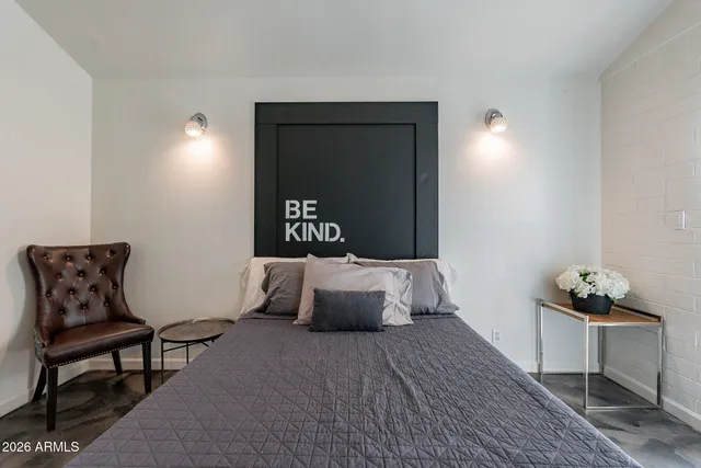 a bedroom with a bed and window