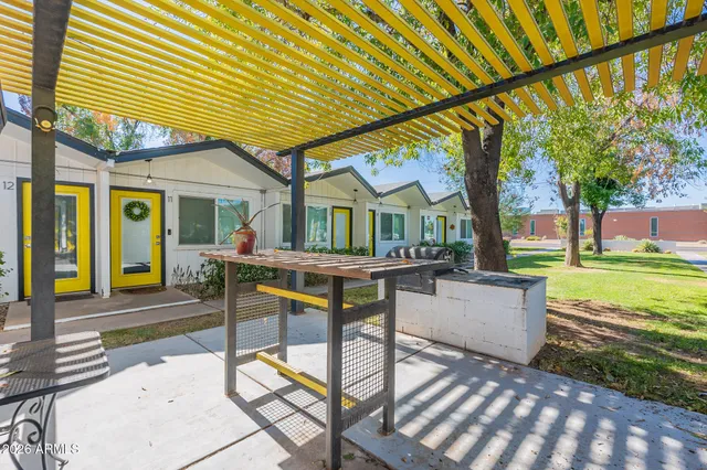 a view of a house with backyard and sitting area